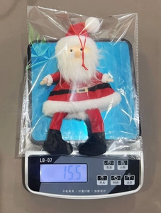 Detailed view of plush Santa Claus ornament weighing 15.5g in clear packaging