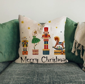 Detailed view of Christmas nutcracker pillow cover on sofa with Merry Christmas print