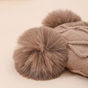 Classic tan knit winter hat for kids with dual fluffy pom-poms and warm fleece lining