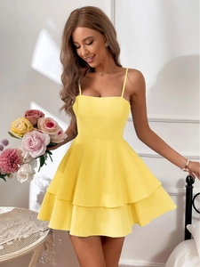 Close-up of tiered hemline on yellow cotton summer dress with high waist bow detail