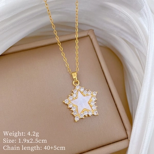 Detail of star pendant necklace with shell inlay and cubic zirconia on silk background