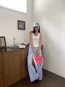 Chic model style featuring a hot pink Paris embroidered tote bag with casual summer outfit
