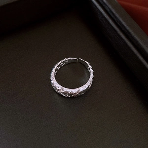 Detailed close-up of adjustable silver twist ring with hammered vintage texture finish