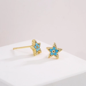 Minimalist 18K gold-plated star stud earrings with blue zircon inlays on a white stand