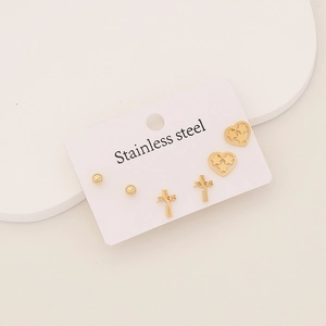 Detailed view of three pairs of gold stainless steel stud earrings on a display card