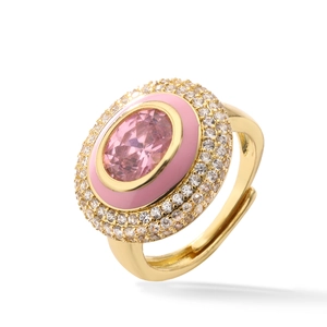 Detailed macro view of an oval pink gem ring with enamel and zircon on a gold band