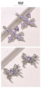 Detailed view of violet enamel north star and butterfly pendants with purple zircons