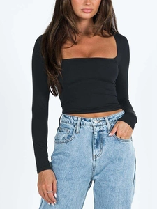 Close-up of slim-fit black square neck crop top paired with high-waist light blue denim