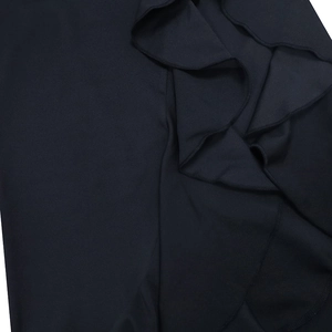 Macro shot of black ruffled hem and premium fabric texture on an evening dress