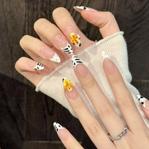 Handmade pink almond press-on nails with zebra pattern and 3D yellow flower accents