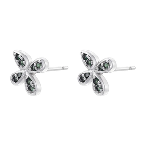 Detail of silver bow earrings set with vibrant green cubic zirconia on a white background
