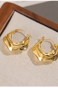 Macro detail of 18K gold plated V-shape wrinkled hoop earrings with high polish finish