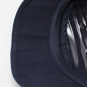 Detail of navy blue cotton twill newsboy cap showing precise stitching and fabric texture