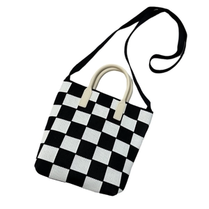 Knitted checkerboard tote bag with black and white pattern and round handles