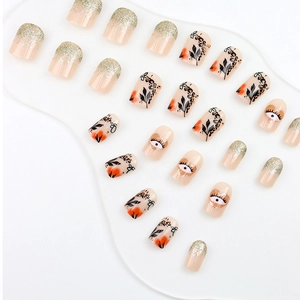 Press-on nail set with gold glitter, leopard print, and eye motifs on a nude base