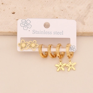 Three pairs of gold stainless steel earrings featuring flower studs and hoop drops
