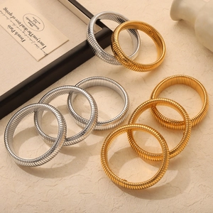 Textured gold and silver snake bone elastic bracelets with polished metallic finish