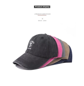 Stacked vintage washed cotton baseball caps with rose embroidery and Forever text in five colors