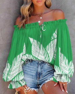 Detail of off-shoulder neckline with drawstring tie and green leaf print patterns