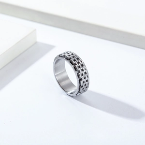 Detailed close-up of double-layer rotating titanium steel ring with industrial chain texture
