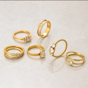 Detailed view of a 6-piece gold stainless steel ring set with sparkling cubic zirconia