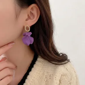 French vintage purple petal earrings with gold rings shown on a female model