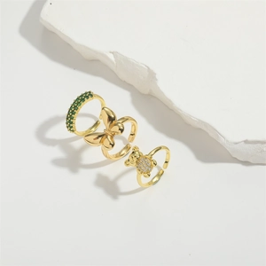 Elegant gold adjustable rings set with green zircon, bow design and bear shape details