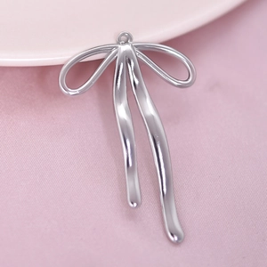 Detail shot of silver 304 stainless steel bow pendant with a polished metallic finish