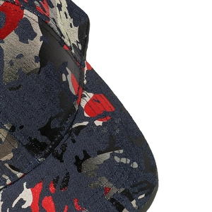 Detailed close-up of navy blue camouflage denim texture on the sturdy baseball cap crown
