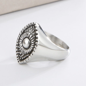 Detail of vintage silver titanium steel ring with sun pattern and devil eye engraving