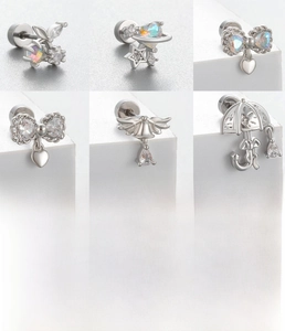 Macro display of assorted titanium steel ear studs with butterfly and zircon details