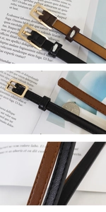 Detail view of thin faux leather belts with golden alloy buckle and textured finish