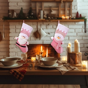 Pink Nordic Christmas stockings with plush Santa and Snowman hanging by a fireplace