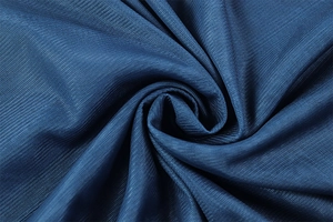 Macro shot of deep blue mesh fabric texture with elegant pleated ripples and fine mesh detail