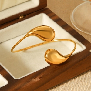 Polished 18k gold plated stainless steel teardrop open bangle in a luxury wooden box