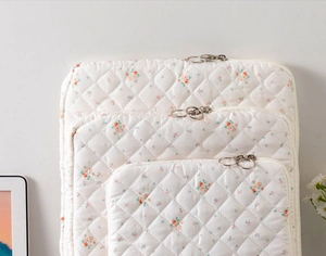 Three-piece set of quilted floral laptop sleeves with silver ring zippers and soft padding