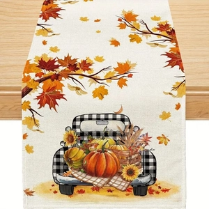 Detail of autumn table runner with vintage truck, pumpkins and sunflowers on wood surface