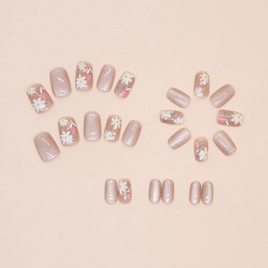 Detail of cat-eye press-on nails with white daisies and pink floral hand-painted designs