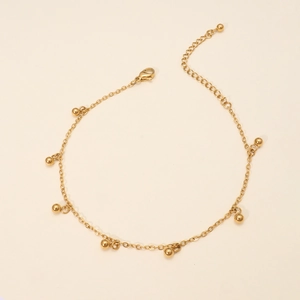Detail of 18K gold plated bead bracelet with adjustable lobster clasp and polished finish