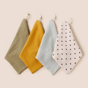 Detail of 4-pack muslin cotton baby face towels with hanging loops and wrinkled texture