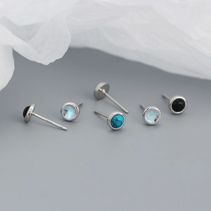 Macro shot of s925 silver earrings featuring turquoise, agate and opal stones