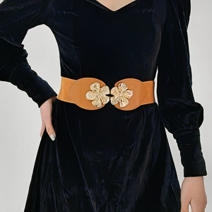 Detail of a brown elastic waist belt with a golden double peach blossom metal buckle
