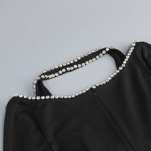 Detail of black V-neck dress with silver rhinestone embellishment and hidden zipper