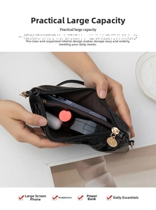 Detailed view of black crocodile pattern bag showing spacious interior compartment