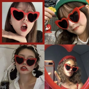 Red heart-shaped sunglasses with dark lenses on diverse models for a chic party look