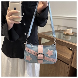Detail of Y2K denim shoulder bag with pink leather stars and metal chain straps