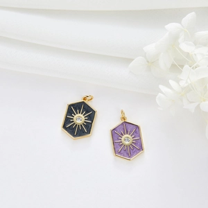 Detailed macro of gold-plated hexagonal pendants with sun pattern and zircon stones