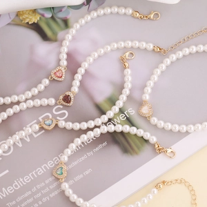 Elegant 18K gold plated bracelet featuring pearls and colorful zircon heart pendants