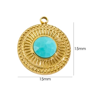 Detail view of 15mm round gold plated 14K stainless steel charm with faceted blue stone