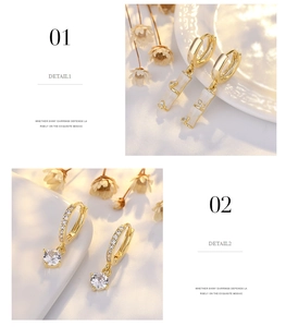 Detail of gold S925 silver hoop earrings with sparkling zircon pendants and floral accents